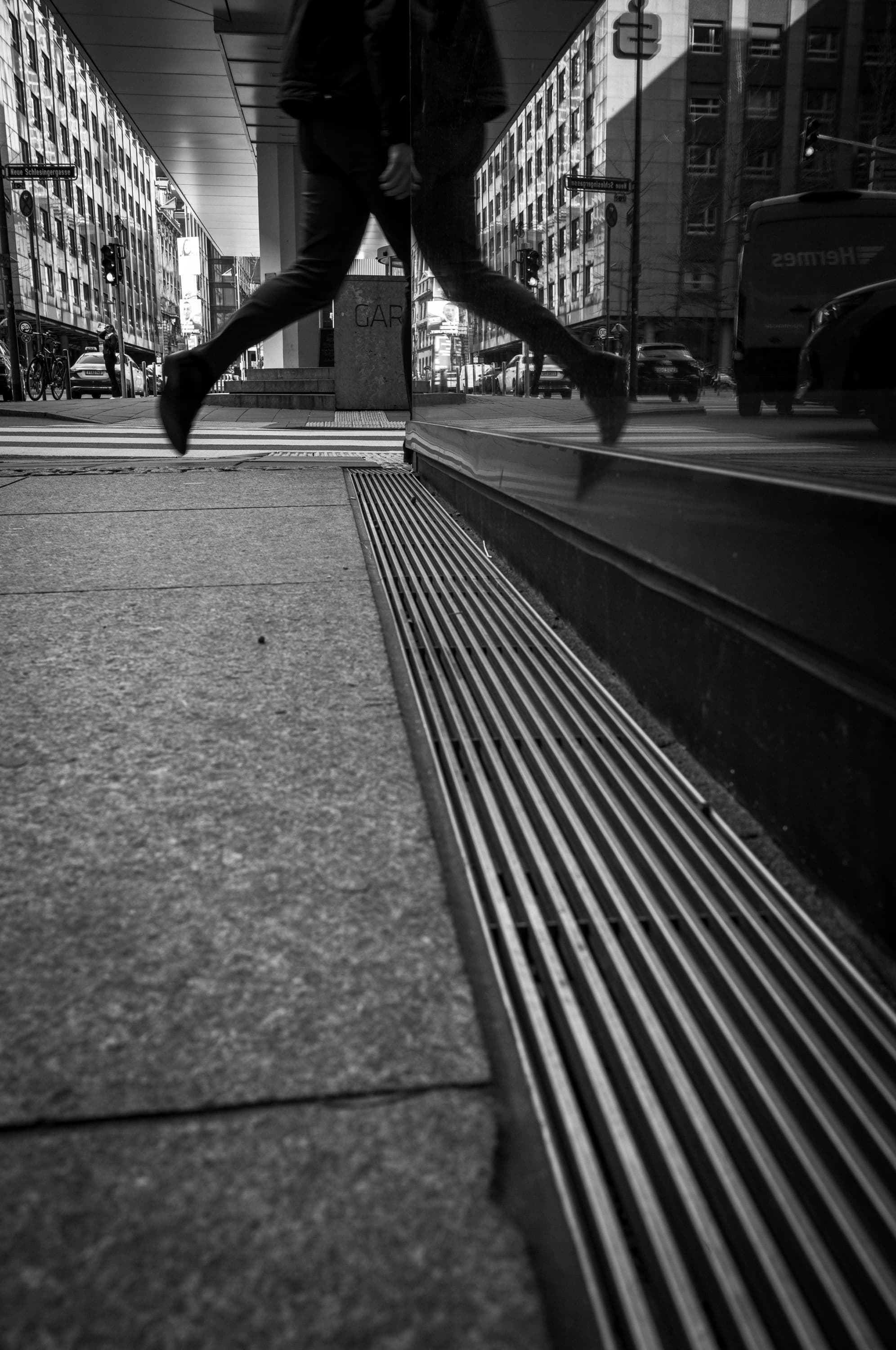 Low street perspective with reflected movement - at the glass.