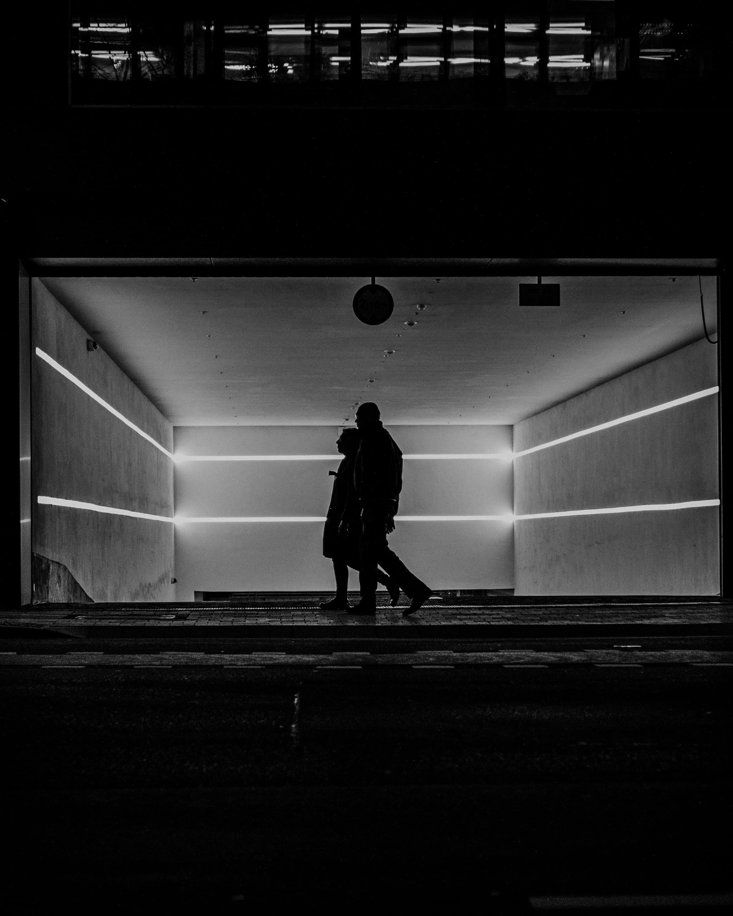 Dark figures in front of light lines - in shadow.