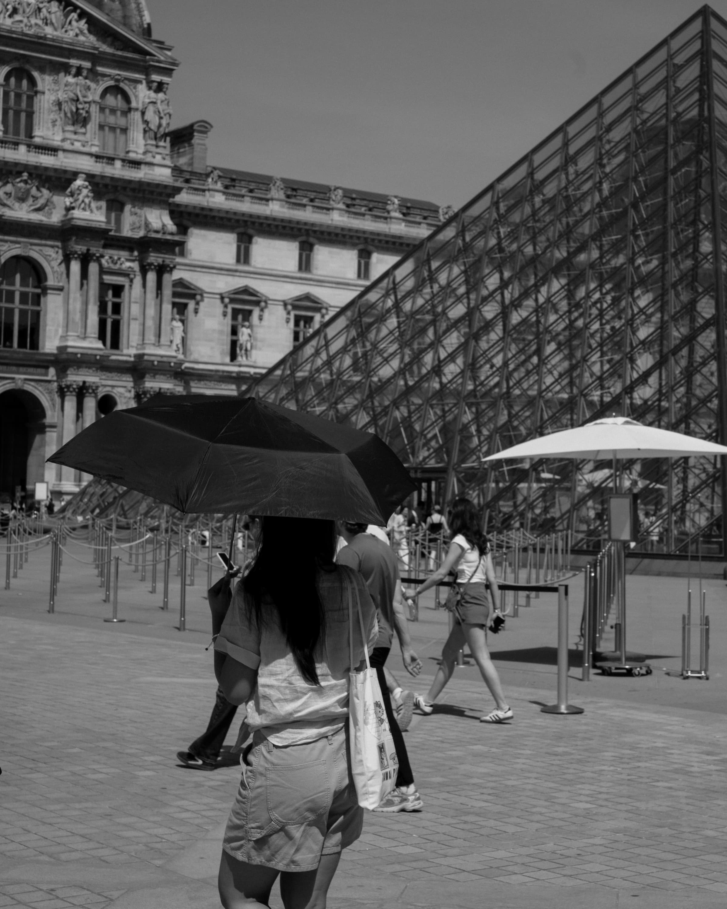 Louvre square with umbrellas - at the louvre.