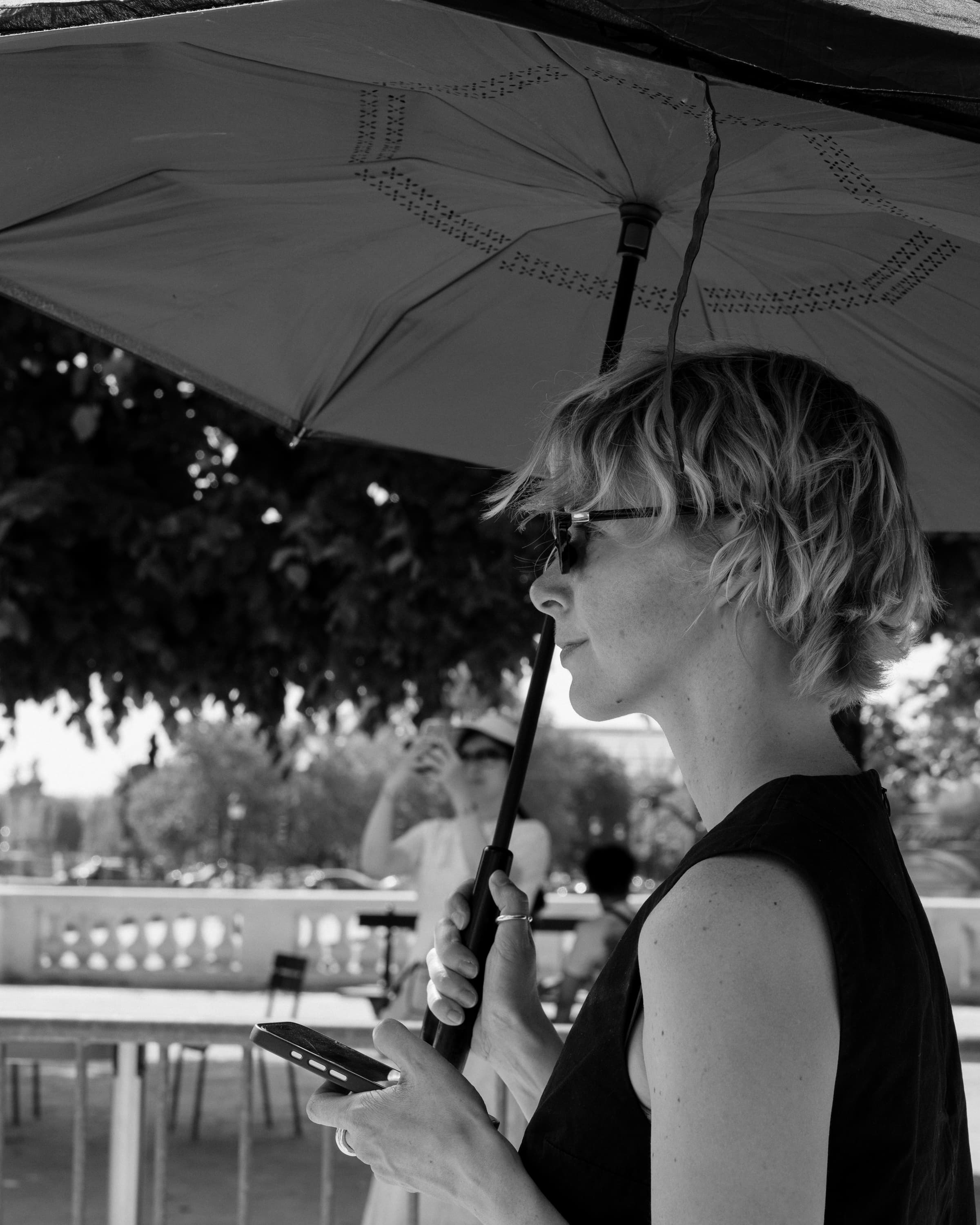 Profile under an umbrella by the river - in shade.